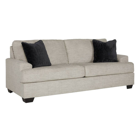 Sofa condo en tissu beige pâle avec coussins - Vayda