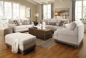 Ottoman en tissu beige pâle avec garniture cloutée - Harleson