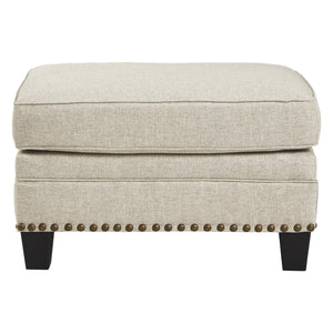 Ottoman en tissu beige effet lin avec garniture cloutée - Claredon